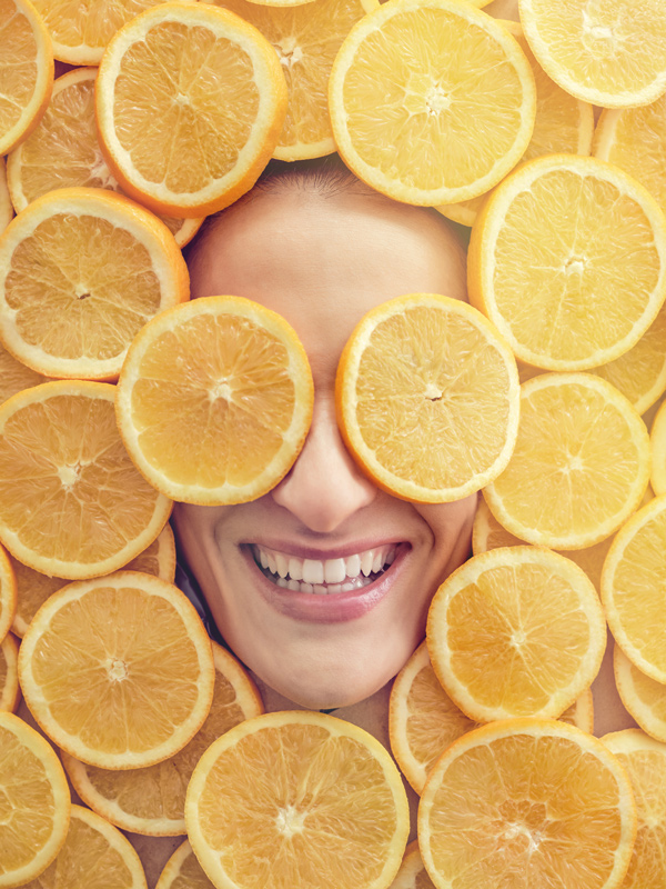 a woman's face surrounded by slices of oranges Glutathione