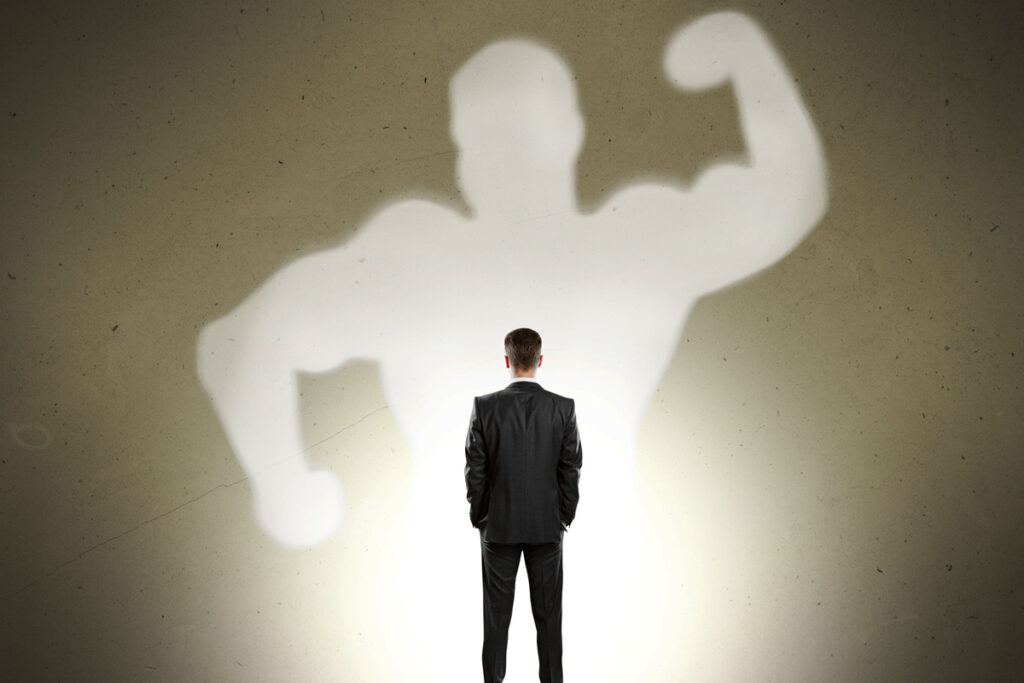 a man looking at a shadow of a man