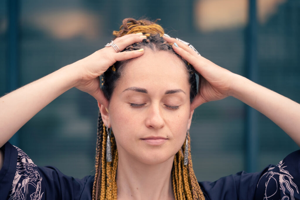 a woman with her hands on her head