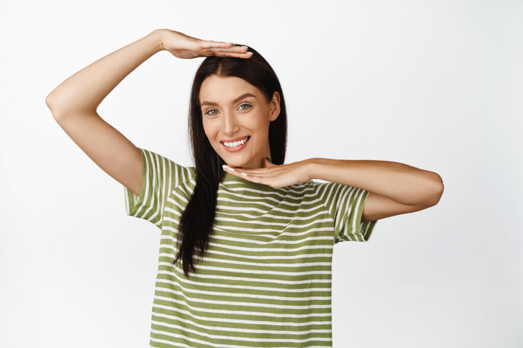 a woman with her hands over her head